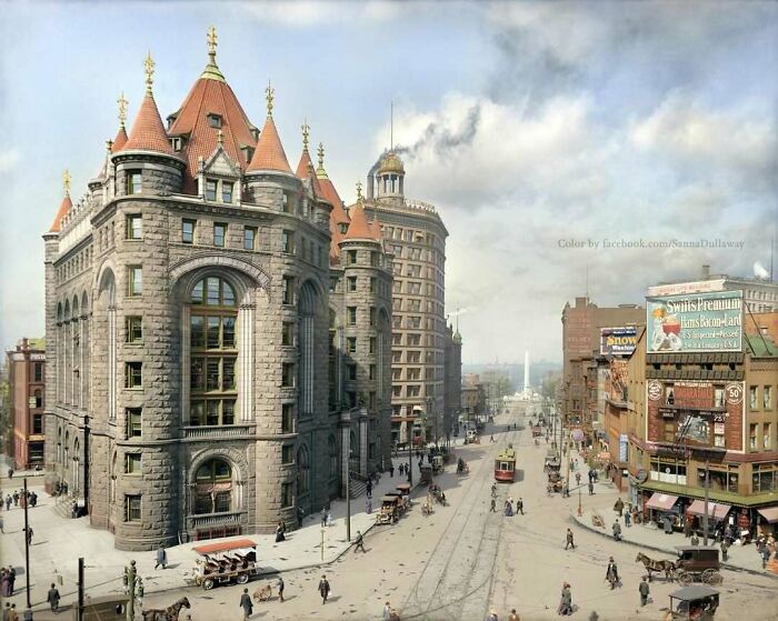 Historic city street scene featuring stunning old American architecture with tall, ornate buildings and vintage trams.