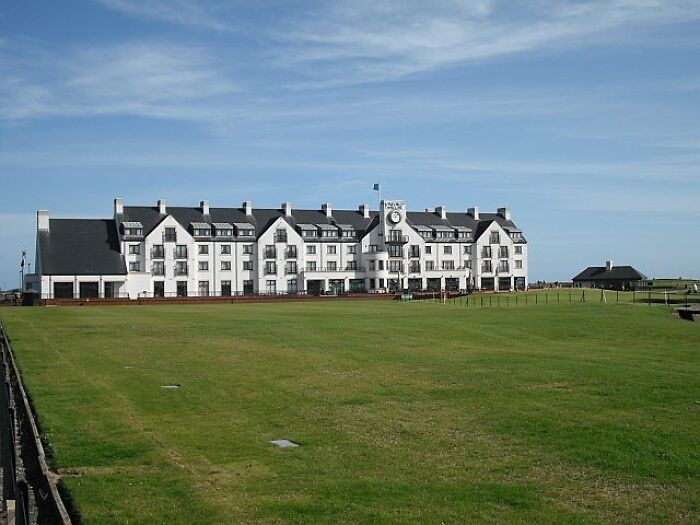 Breathtaking golf course with a grand clubhouse, ideal for golfers traveling globally to play a round.