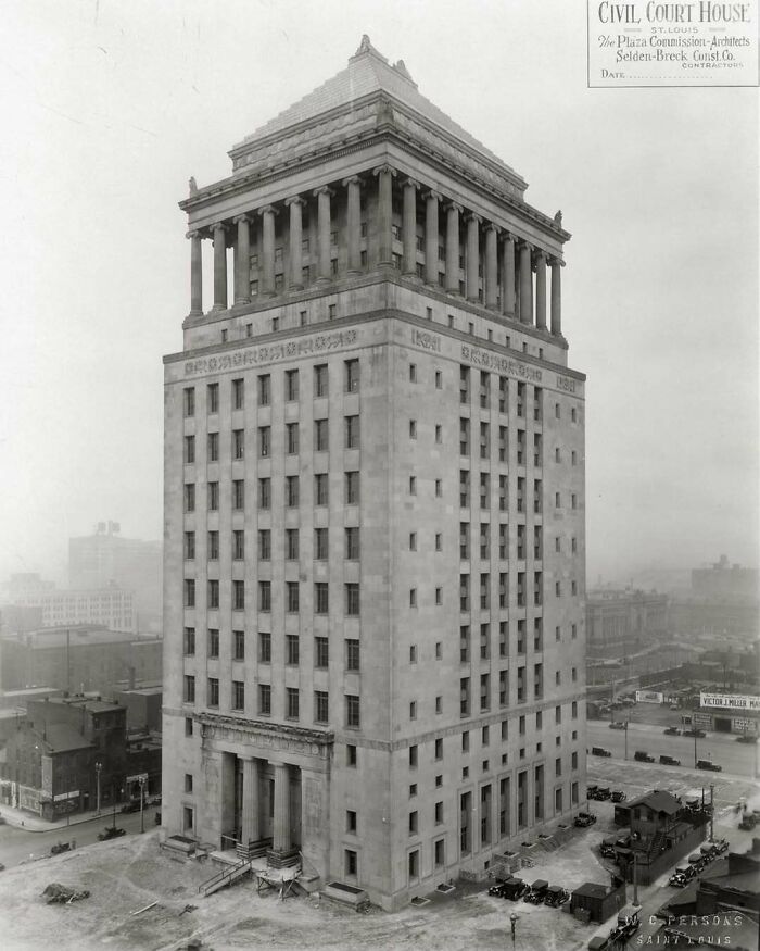 Grand civil courthouse showcasing old American architecture, surrounded by early 20th-century cityscape.
