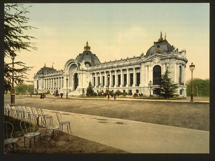 Neo-Baroque style building with ornate details and a row of empty chairs, showcasing old American architecture.