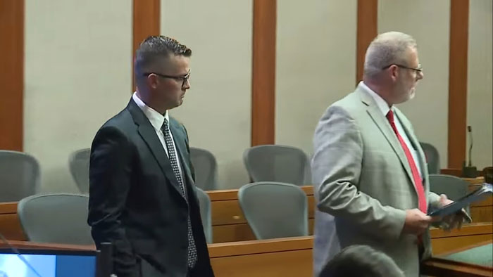 Man in a courtroom during legal proceedings related to a neglect case involving a child in a hot car. Man in a courtroom during legal proceedings related to a neglect case involving a child in a hot car.