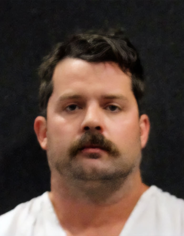 Man with dark hair and mustache against a dark background, related to plea deal rejection case. Man with dark hair and mustache against a dark background, related to plea deal rejection case.