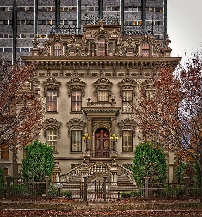 Historic American architecture with ornate facade and grand entrance, framed by trees in an urban setting.