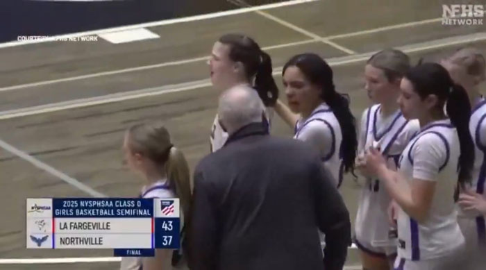 High school basketball coach with team during semifinal game, scoreboard showing La Fargeville leading Northville. High school basketball coach with team during semifinal game, scoreboard showing La Fargeville leading Northville.