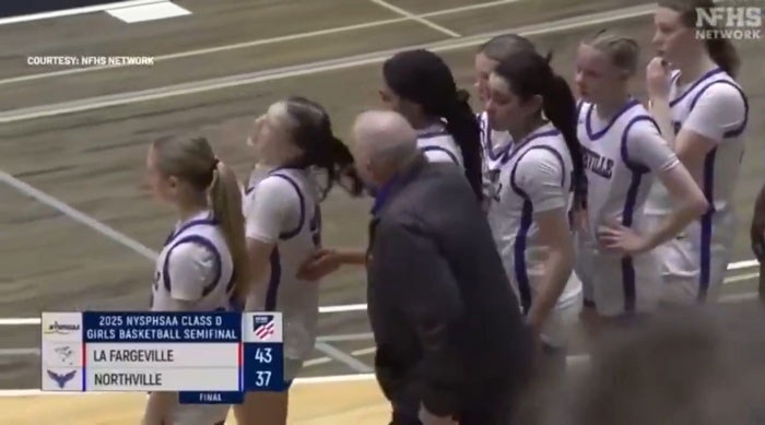 High school basketball coach pulling a girl's hair during a game. High school basketball coach pulling a girl's hair during a game.
