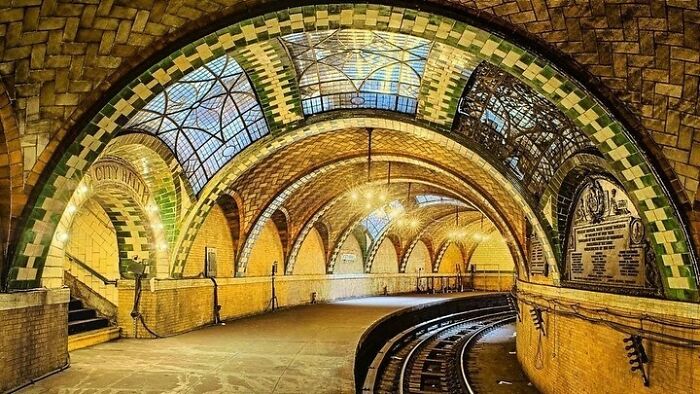 Historic subway station with arched ceilings and mosaic tiles showcasing old American architecture.