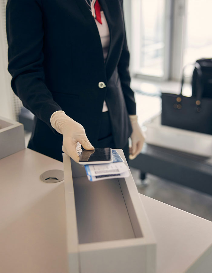 Airport security staff checking boarding pass and ID at gate counter. Airport security staff checking boarding pass and ID at gate counter.