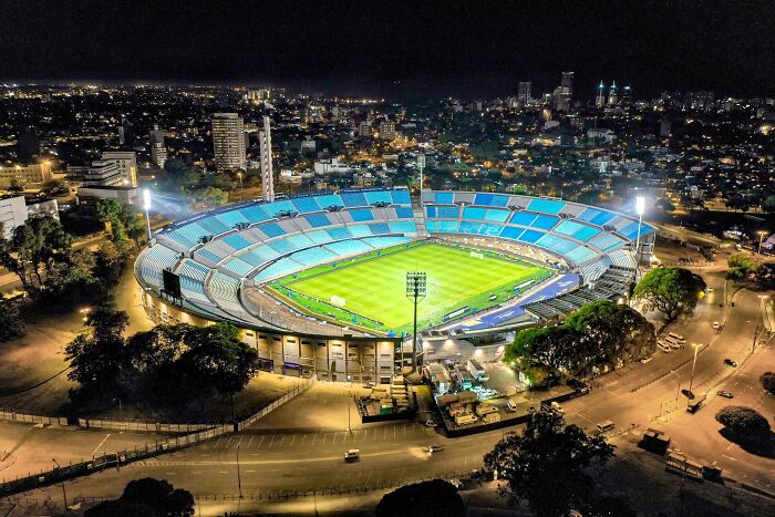 A brightly lit soccer stadium at night, one of the iconic cathedrals of soccer where legends are born.