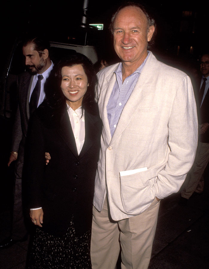 Man and woman smiling together at an event; SEO keyword: Gene Hackman. Man and woman smiling together at an event; SEO keyword: Gene Hackman.