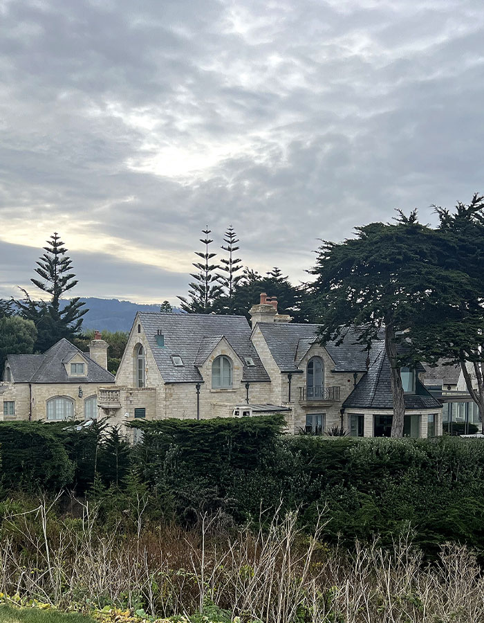 Stone house surrounded by trees under a cloudy sky, related to Gene Hackman in recent news. Stone house surrounded by trees under a cloudy sky, related to Gene Hackman in recent news.