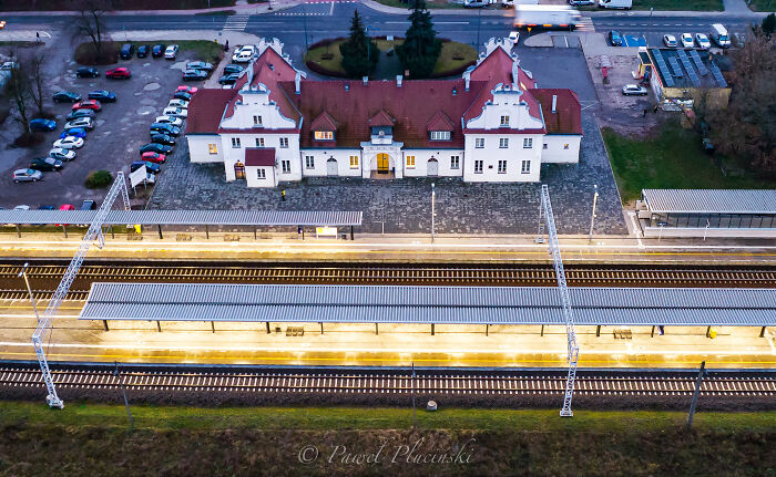 Aerial view of a historic train station with tracks and platforms, showcasing the city's architecture.