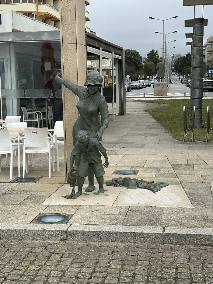 Statue In Beach Town In Portugal. Is She Going To Give This Boy A Spanking?