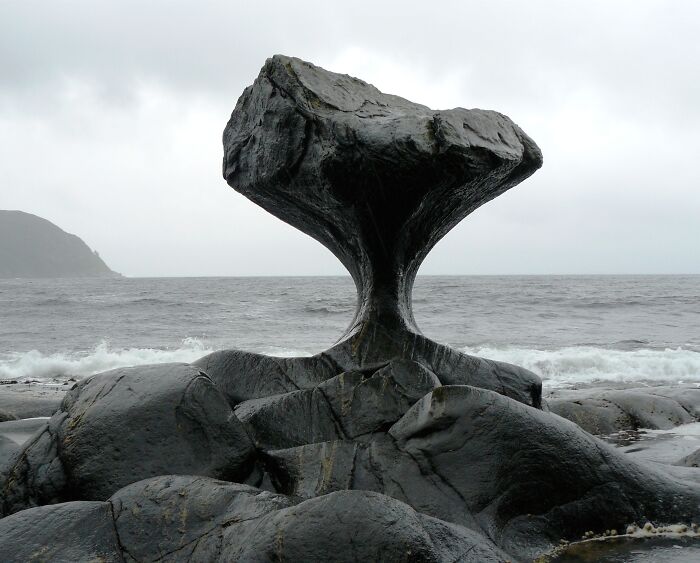 Ancient rock formation by the sea, illustrating the effects of time on natural things.