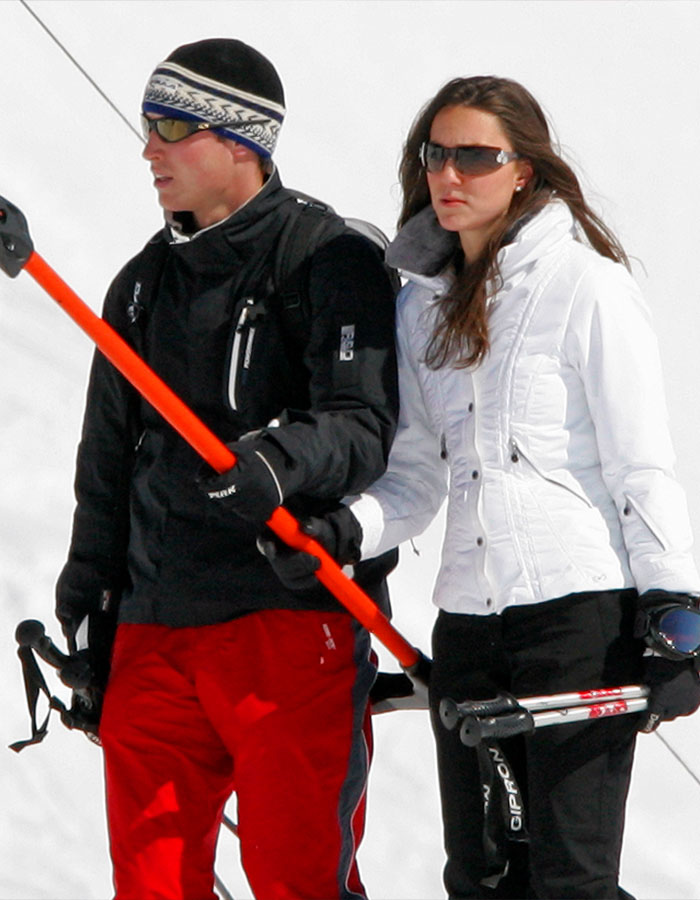 Young couple skiing in winter outfits, holding ski poles, highlighting pre-princess era photos of Kate Middleton. Young couple skiing in winter outfits, holding ski poles, highlighting pre-princess era photos of Kate Middleton.