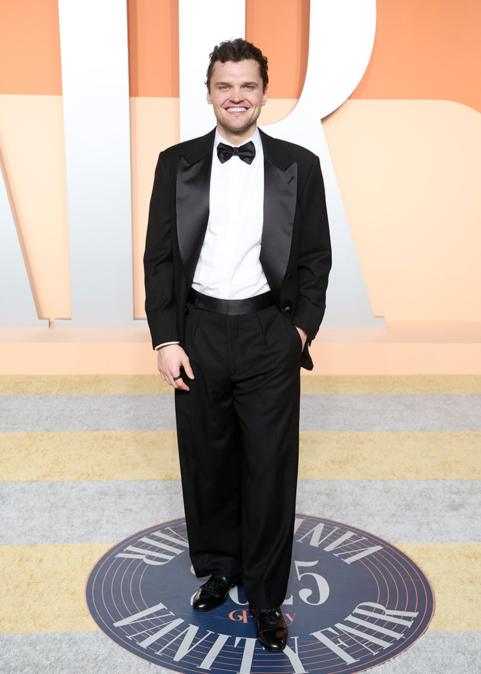 Ray Nicholson in a tuxedo smiling at the Oscars after party, embodying the nepo baby trend on the red carpet. Ray Nicholson in a tuxedo smiling at the Oscars after party, embodying the nepo baby trend on the red carpet.