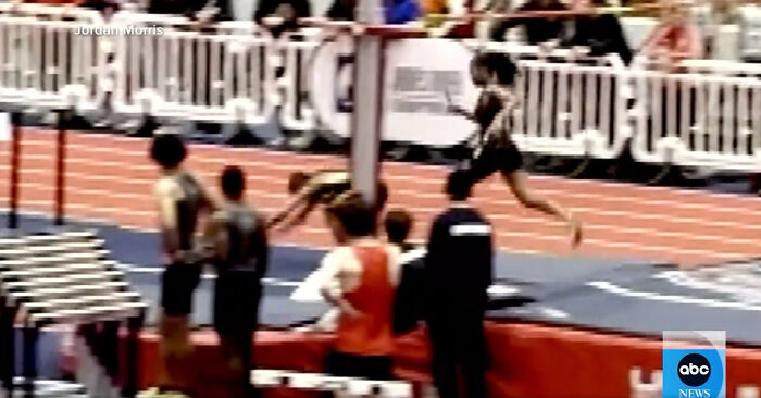 Athlete in mid-run during a track event, highlighting a controversial incident with an opponent. Athlete in mid-run during a track event, highlighting a controversial incident with an opponent.