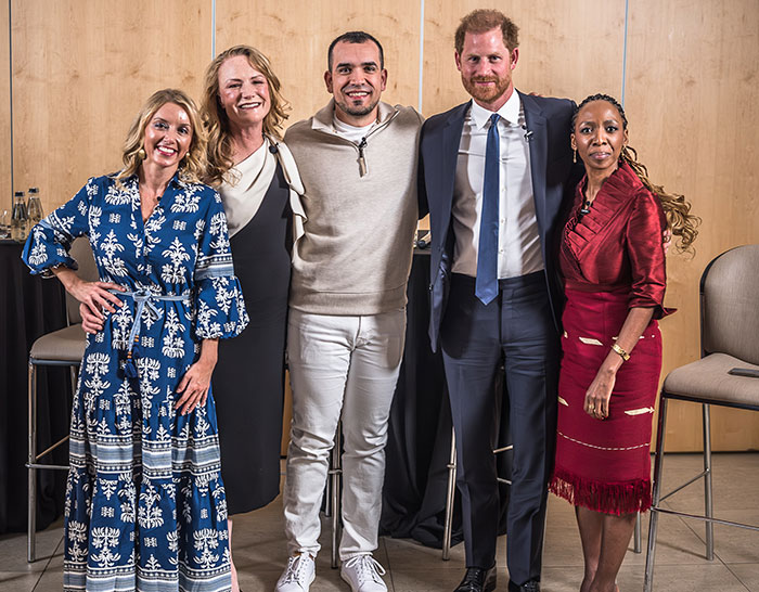Group of five people smiling at a charity event. Group of five people smiling at a charity event.