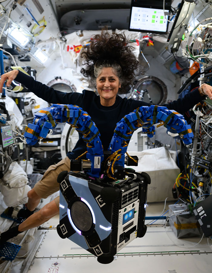 Astronaut floating in space station, hair defying gravity, showcasing effects of nine months in space. Astronaut floating in space station, hair defying gravity, showcasing effects of nine months in space.