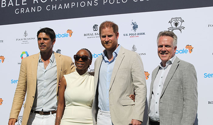 Four people in formal attire at a polo event backdrop; SEO keyword: Prince Harry charity accusations. Four people in formal attire at a polo event backdrop; SEO keyword: Prince Harry charity accusations.