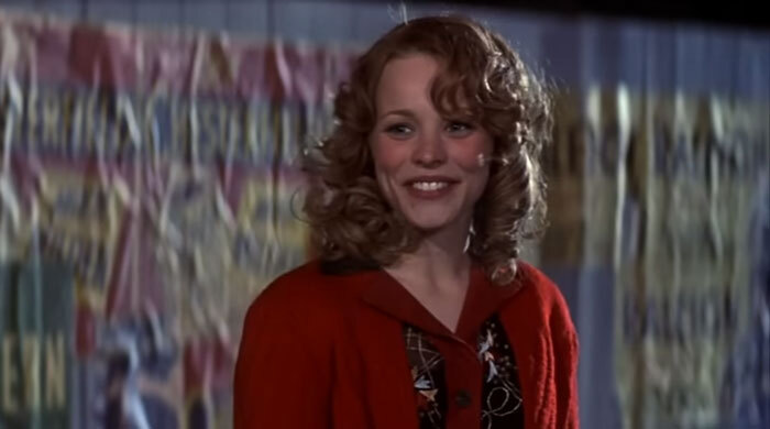 Person smiling in a red coat against a colorful background, representing popular celebrities admired by netizens.