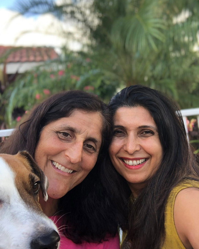Two women smiling with a dog, related to NASA astronaut's psychological trauma in space. Two women smiling with a dog, related to NASA astronaut's psychological trauma in space.