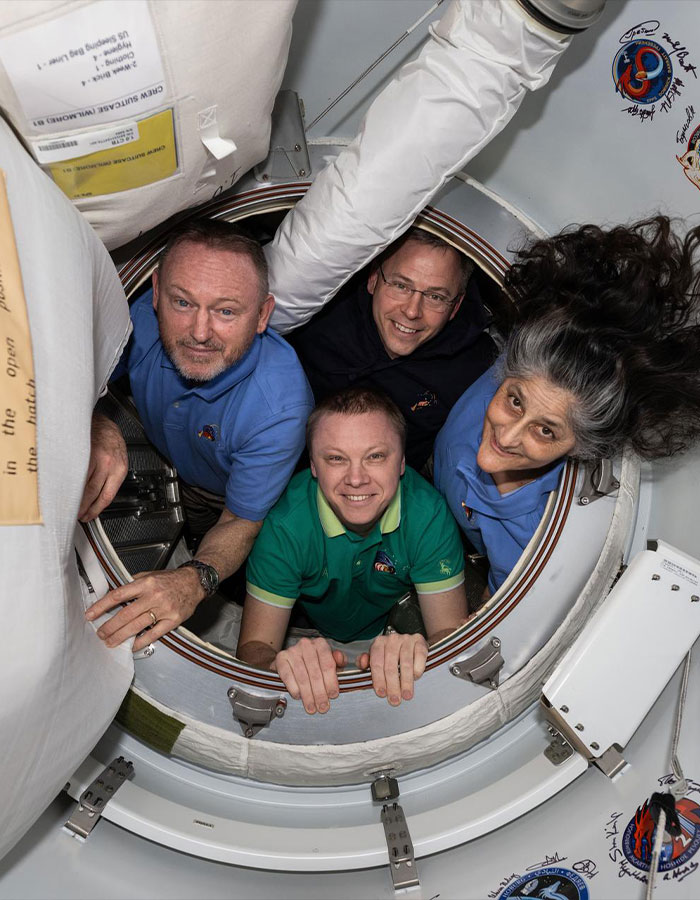 Astronauts inside a spacecraft hatch, illustrating effects of 9 months in space. Astronauts inside a spacecraft hatch, illustrating effects of 9 months in space.