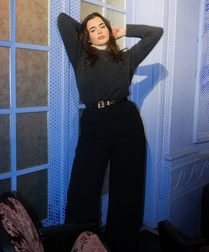 Barbie Ferreira posing confidently in a stylish outfit against a blue backdrop. Barbie Ferreira posing confidently in a stylish outfit against a blue backdrop.