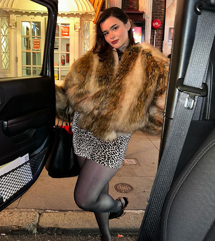 Barbie Ferreira in a fur coat and leopard skirt, standing by a car on a city street. Barbie Ferreira in a fur coat and leopard skirt, standing by a car on a city street.