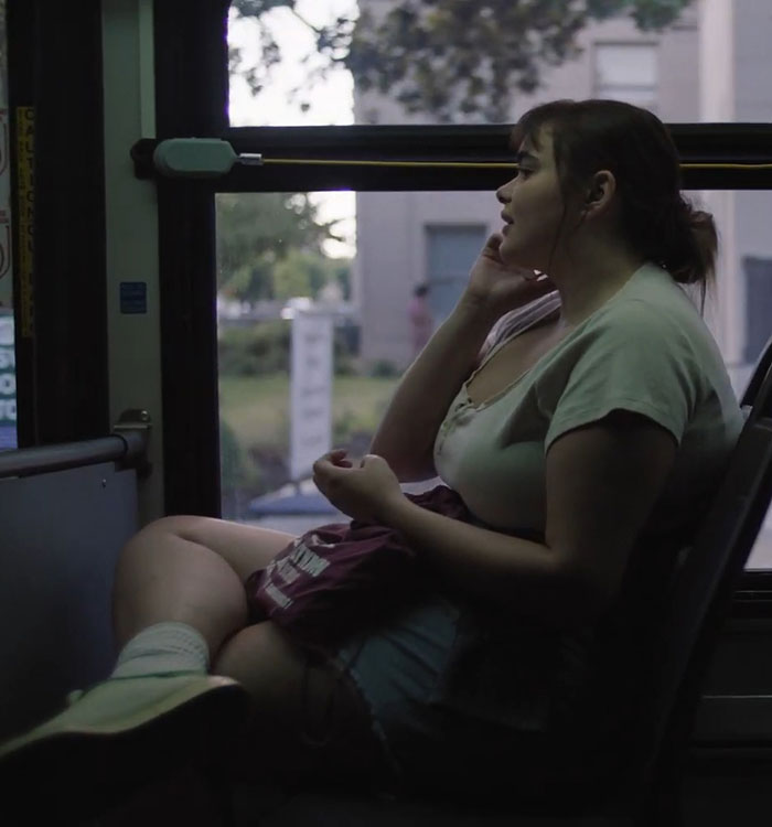 Barbie Ferreira on a bus, sitting by the window, deep in thought, in a scene from a movie before losing weight. Barbie Ferreira on a bus, sitting by the window, deep in thought, in a scene from a movie before losing weight.