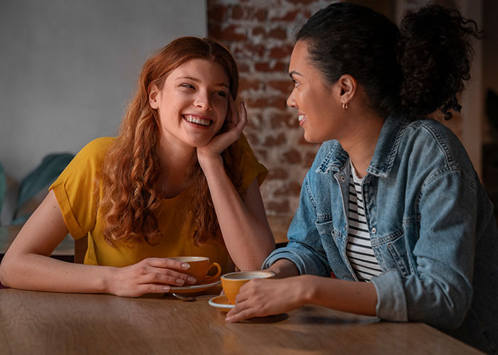 Two women enjoying coffee together, discussing a wedding and bridesmaid roles. Two women enjoying coffee together, discussing a wedding and bridesmaid roles.