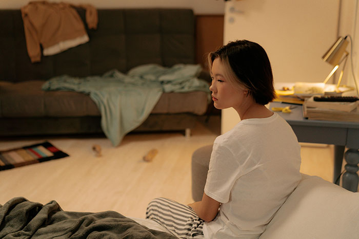 Person sitting in a cluttered room, reflecting on a best friend trash living situation, surrounded by scattered items. Person sitting in a cluttered room, reflecting on a best friend trash living situation, surrounded by scattered items.