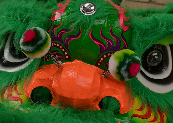 Colorful dragon mask with green fur and orange nose. Colorful dragon mask with green fur and orange nose.