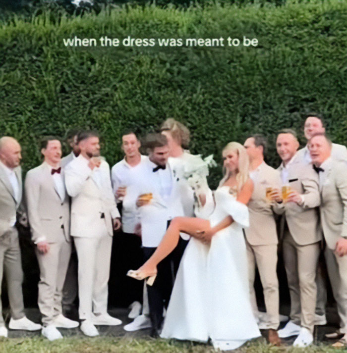 Bride playfully flashes underwear during wedding photoshoot with the groomsmen. Bride playfully flashes underwear during wedding photoshoot with the groomsmen.