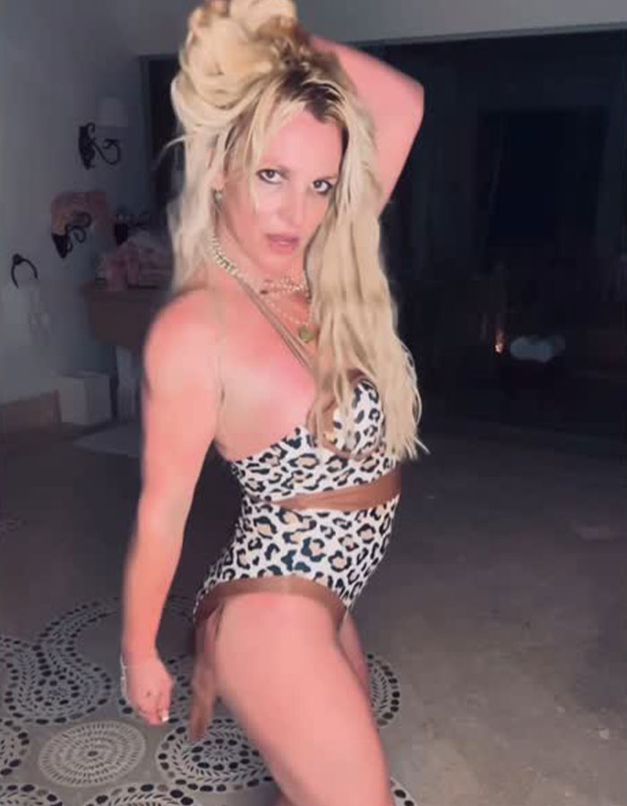 Blonde woman in leopard print lingerie posing indoors amid dim lighting, creating a dramatic and sultry scene. Blonde woman in leopard print lingerie posing indoors amid dim lighting, creating a dramatic and sultry scene.