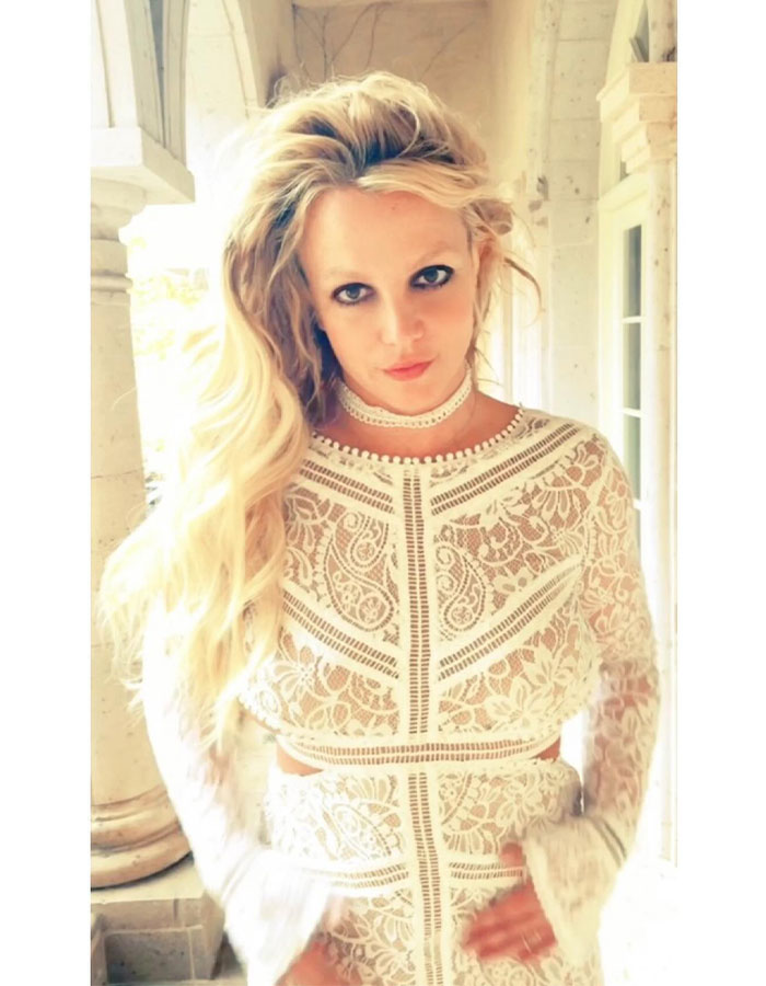 Blonde woman in a white lace outfit standing on a veranda. Blonde woman in a white lace outfit standing on a veranda.