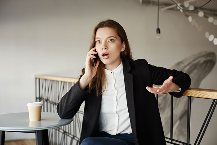 Bride looking baffled during a phone call, expressing surprise, related to a brother's unexpected wedding invitation choice. Bride looking baffled during a phone call, expressing surprise, related to a brother's unexpected wedding invitation choice.