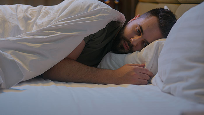 A man lying in bed, appearing pensive, related to brother's unusual +1 choice at a wedding. A man lying in bed, appearing pensive, related to brother's unusual +1 choice at a wedding.