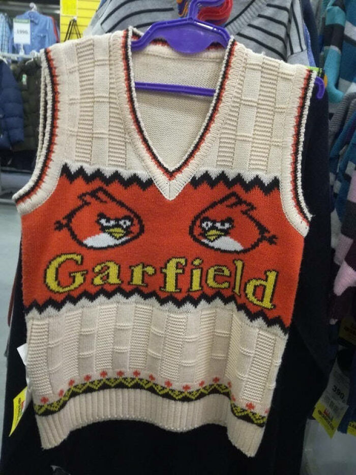 Knitted vest with Garfield text and Angry Birds design, highlighting disastrous design.