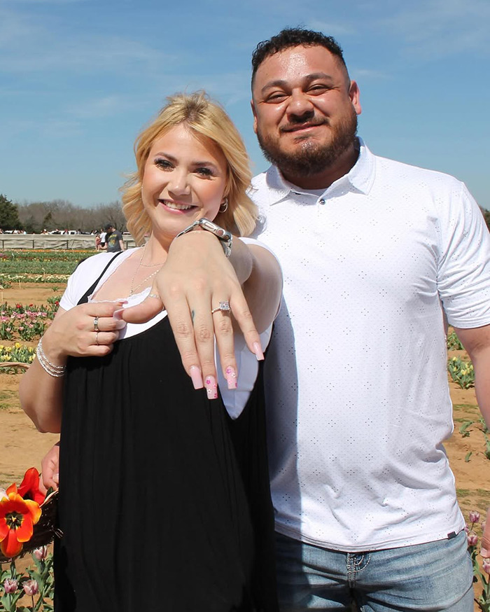 Bride-to-be showing her engagement ring with a man in a field, main SEO keyword: bride-to-be. Bride-to-be showing her engagement ring with a man in a field, main SEO keyword: bride-to-be.