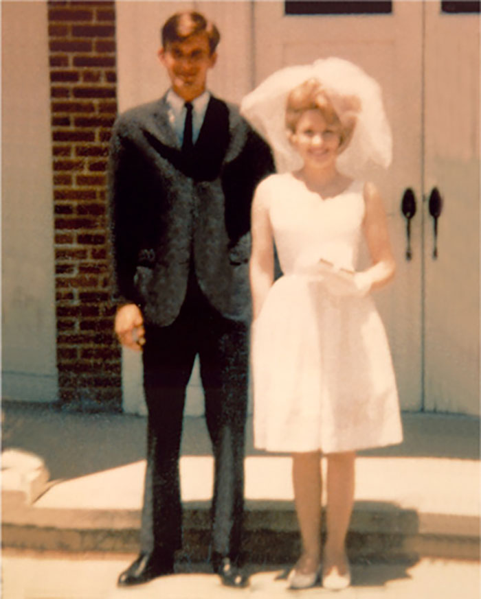 Couple stands together in wedding attire, symbolizing a laundromat love story. Couple stands together in wedding attire, symbolizing a laundromat love story.