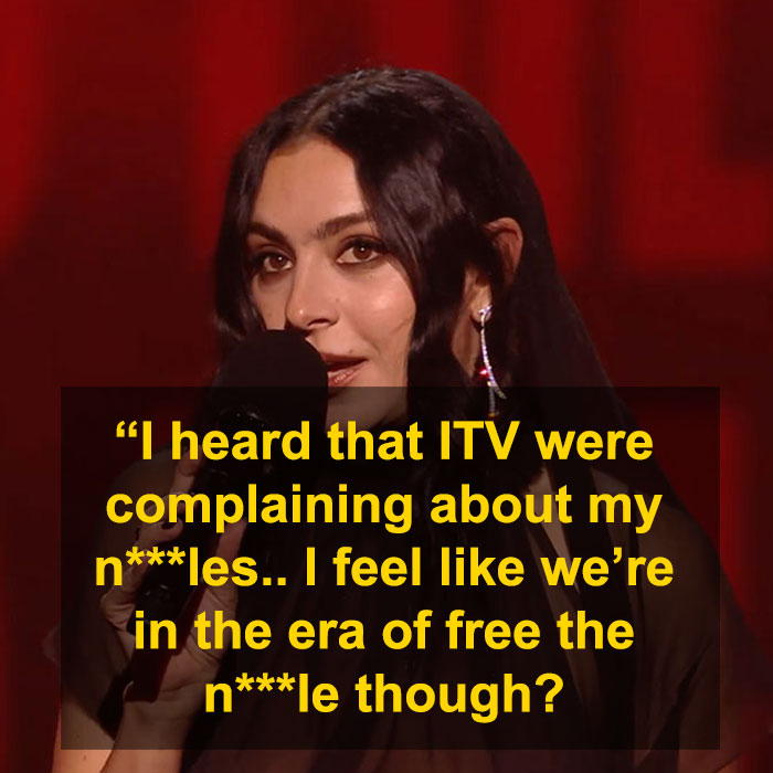Person discussing complaints about a show, mentioning free expression issues with a microphone on stage. Person discussing complaints about a show, mentioning free expression issues with a microphone on stage.