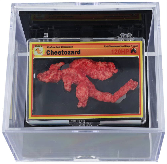 Pokémon-shaped Cheeto in a display case, resembling a game card, purchased for $88K at auction. Pokémon-shaped Cheeto in a display case, resembling a game card, purchased for $88K at auction.