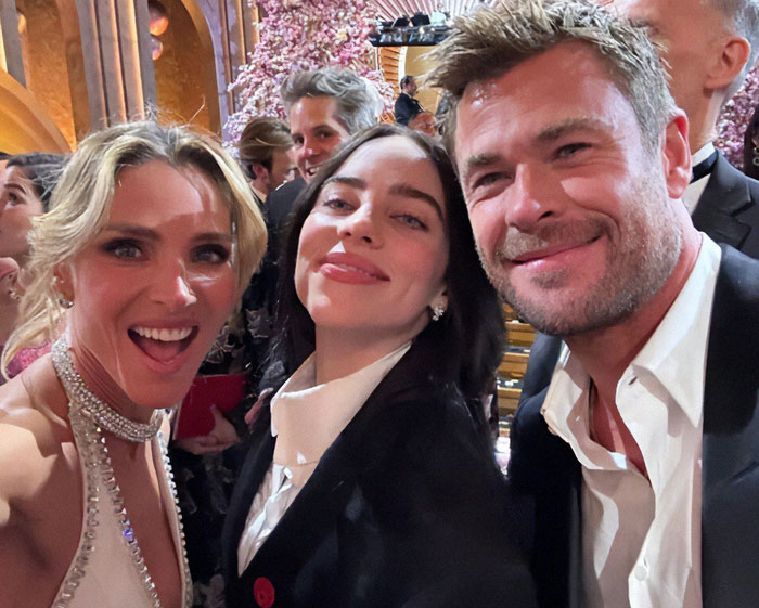 Celebrity selfie at Oscars with smiling attendees, capturing a memorable moment in a crowded, glamorous setting. Celebrity selfie at Oscars with smiling attendees, capturing a memorable moment in a crowded, glamorous setting.