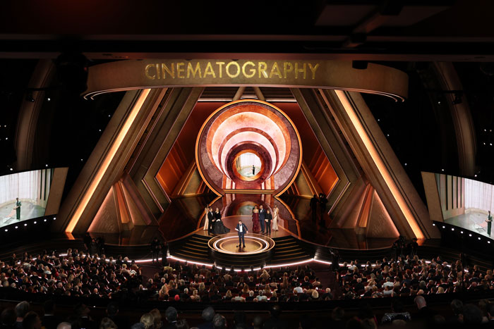 Oscars 2025 ceremony stage with winners receiving an award for cinematography, audience watching. Oscars 2025 ceremony stage with winners receiving an award for cinematography, audience watching.
