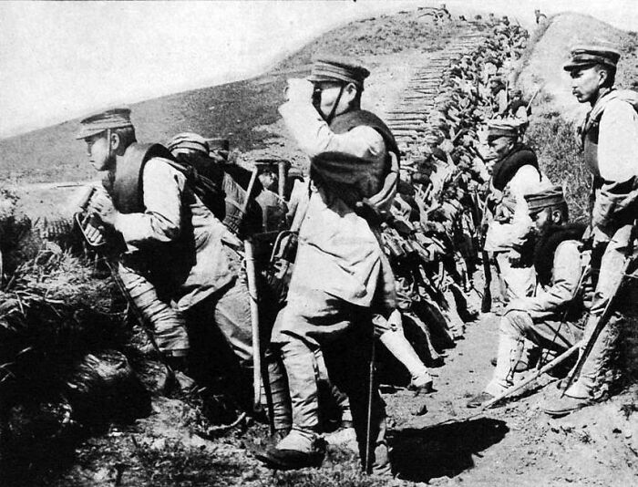 Soldiers in trench observing the battlefield during historical event, aligning with "Napoleon Returning From Exile" theme.