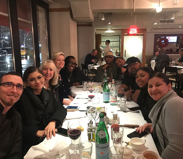 Group dining at a restaurant table, including people with drinks and food, related to Zendaya family rift and wedding. Group dining at a restaurant table, including people with drinks and food, related to Zendaya family rift and wedding.