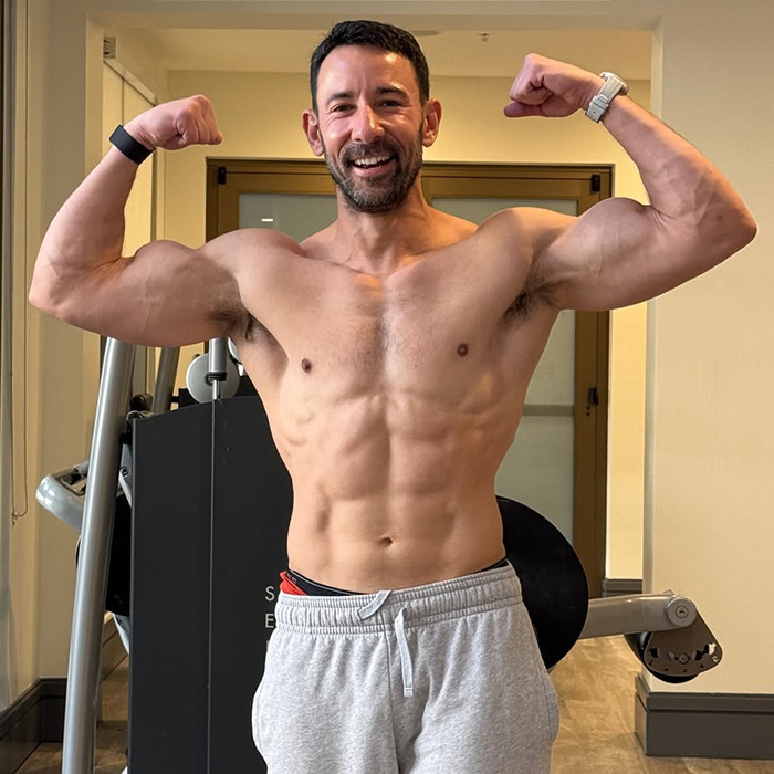 Man flexing muscles in gym setting, related to obesity and fitness discussion. Man flexing muscles in gym setting, related to obesity and fitness discussion.