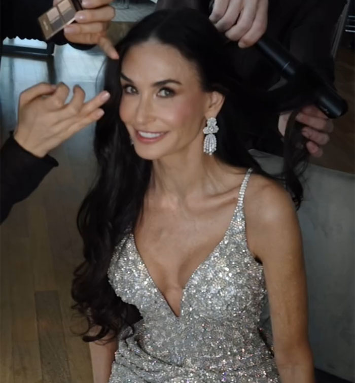 Person in a sparkling dress getting her hair styled, embodying the "Ride Of A Lifetime" theme. Person in a sparkling dress getting her hair styled, embodying the "Ride Of A Lifetime" theme.