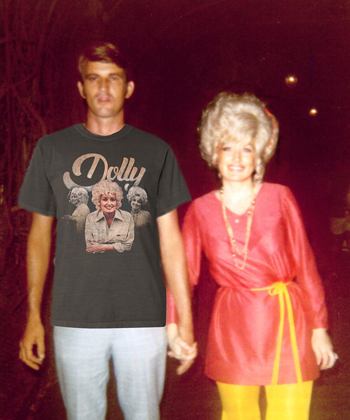 A man in a Dolly Parton t-shirt holds hands with a woman in a red dress. A man in a Dolly Parton t-shirt holds hands with a woman in a red dress.