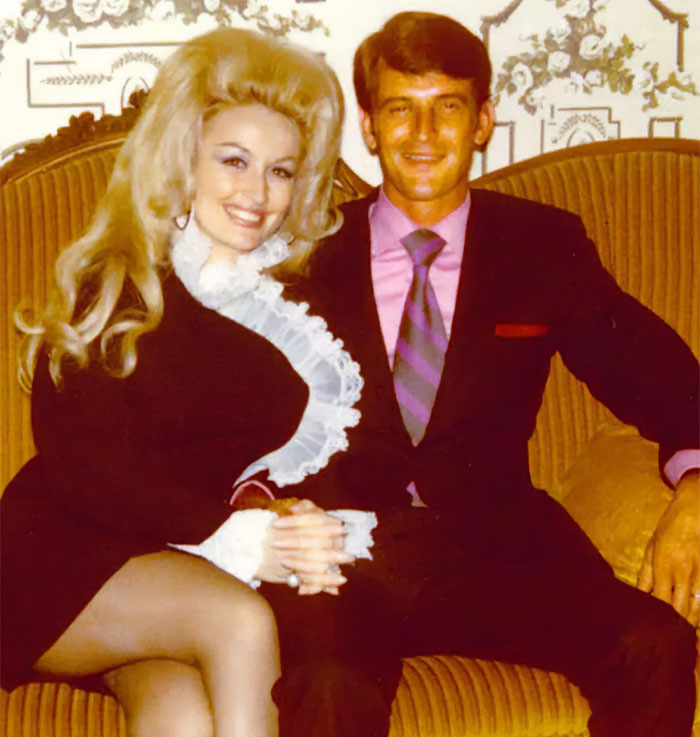 Dolly Parton and Carl Thomas Dean seated together, smiling, showcasing their famous love story. Dolly Parton and Carl Thomas Dean seated together, smiling, showcasing their famous love story.